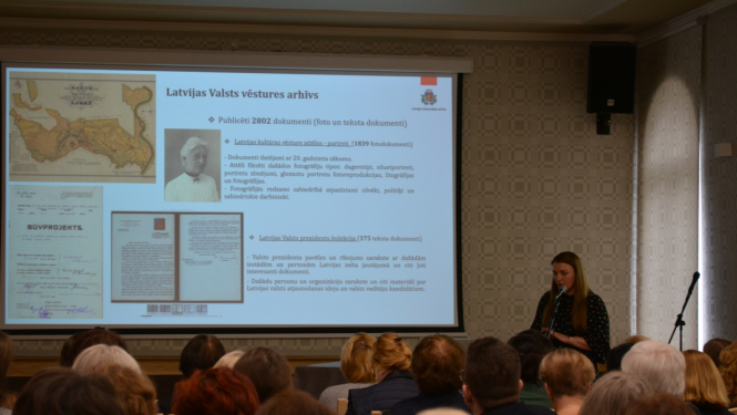 LNA Latvijas Valsts kinofotofonodokumentu arhīva Dokumentu izmantošanas nodaļas eksperte Natālija Lāce iepazīstina klātesošos ar Latvijas Nacionālā arhīva kolekciju apvienošana digitālajā vidē