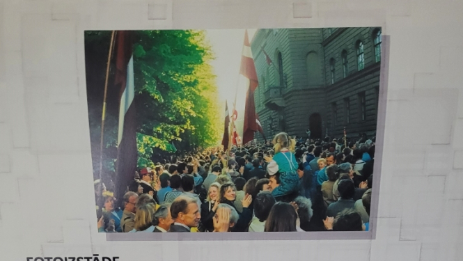 Izstādes afiša, uzraksts "Deklarācija par Latvijas Republikas neatkarības atjaunošanu", divas fotogrāfijas no izstādes